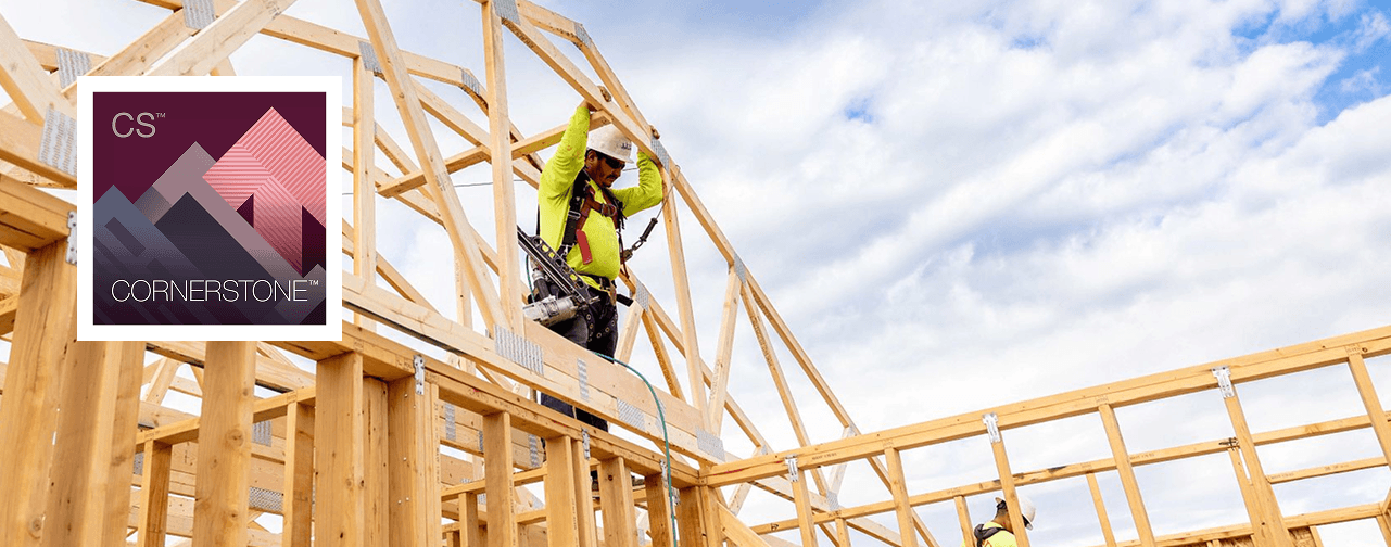 Wood-framed residential structure under construction featuring Cornerstone™ engineered wood products, with roof trusses being installed and wall framing in progress.
